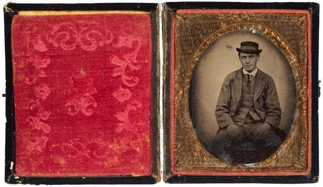 A cased tintype of a smart young man in a hat