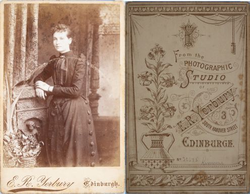 Front and back of a Cabinet Card of a women. The back of the card had an intricately designed trade plate